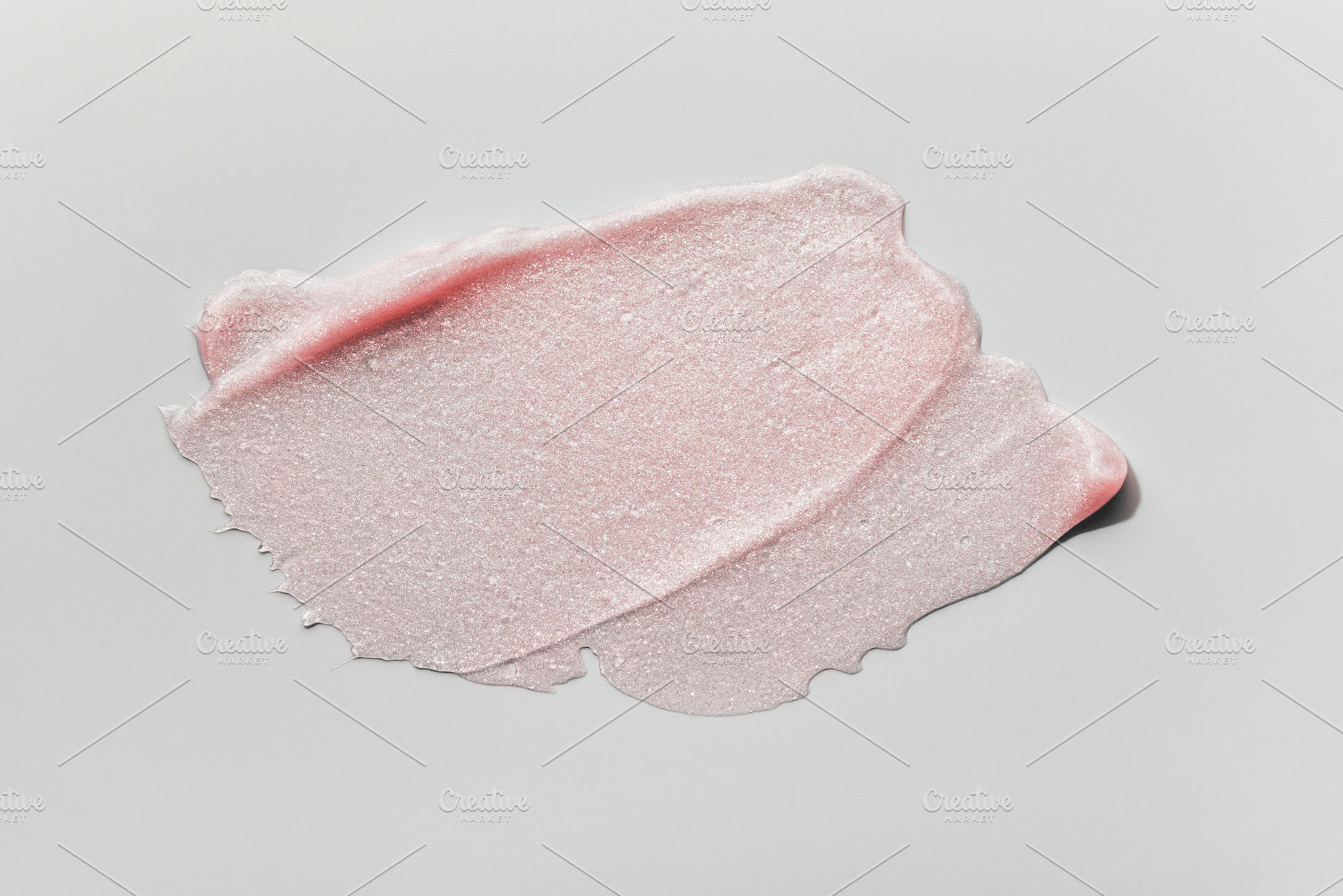 Smears of transparent pink lip gloss or moisturizer with glitter on grey backgr, a Background Photo by colnihko