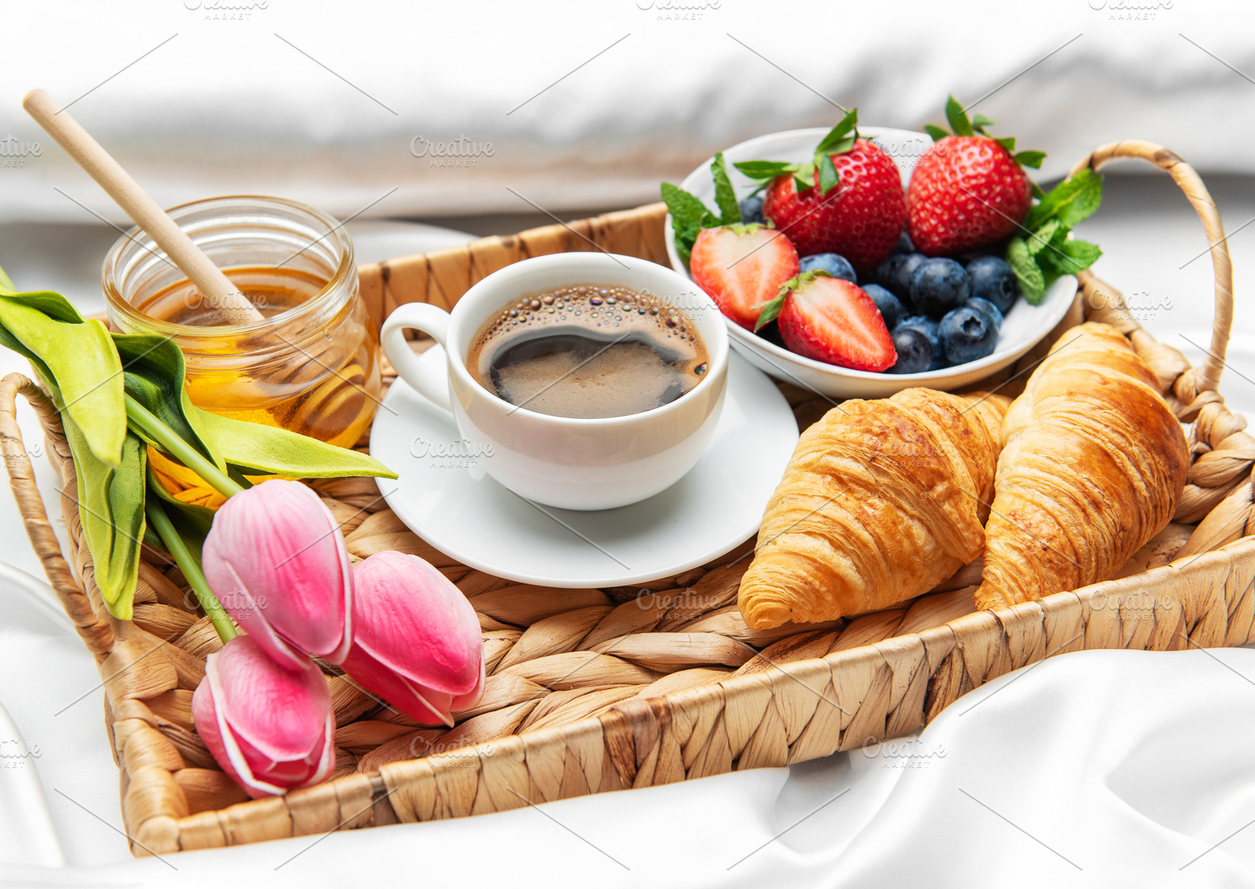 Romantic breakfast in bed with coffee, croissants, berries, hone, a Food & Drink Photo by Olena Rudo