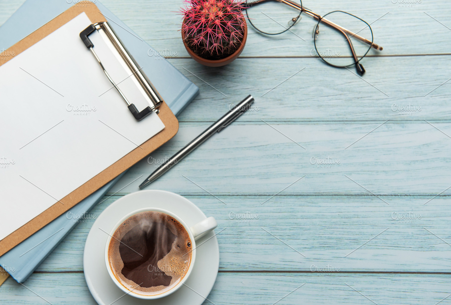 Office desk with coffee, clipboard, eyeglasses and cactus on woo, a Business Photo by Olena Rudo