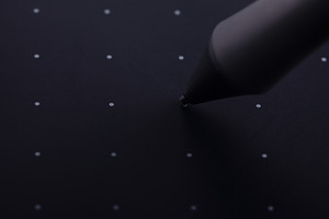 Close-up of a stylus pen tip hovering over a dotted black graphi, a School & Education Photo by Ales Munt