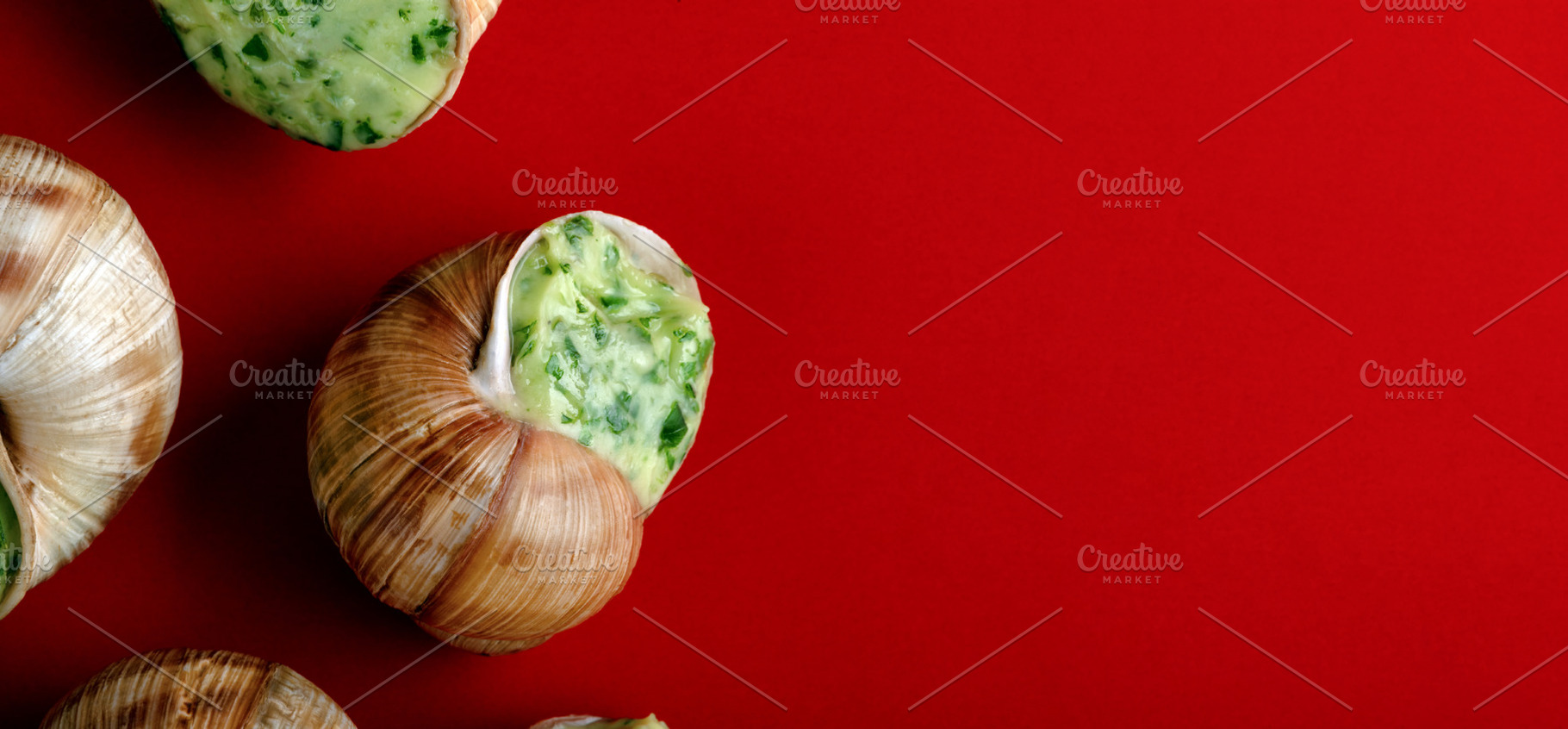Close-up of escargot stuffed with garlic herb butter on a vibran, a Food & Drink Photo by Ales Munt