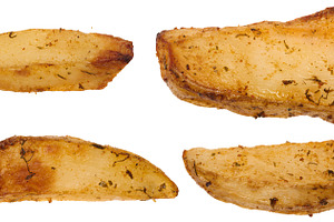 Four baked country style potato wedges with golden crust and dri, a Food & Drink Photo by ndanko