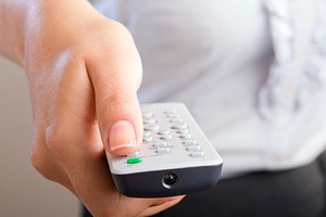 Woman Holding Remote Control, a Background Photo by THP Creative