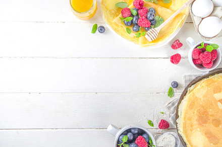 Crepes pancakes with berries, a Background Photo by Rimma