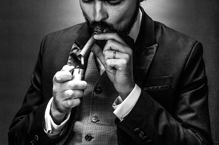gentleman lights a cigar, a Person Photo by Ales Munt