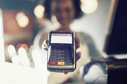 Restaurant waitress holding an electronic card payment machine, a Business Photo by Stefan & Janni