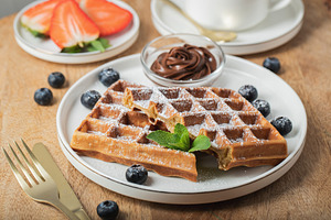 Belgium waffles Homemade waffles with strawberries, a Food & Drink Photo by Budarinphoto