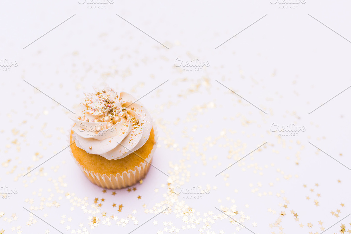White cupcake stock photo containing food, cupcake, and sprinkes, a Food & Drink Photo by The Snap Shop (Photo 2 of 2)