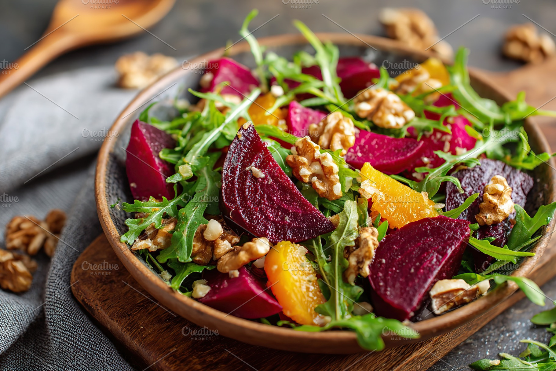 Refreshing beet and arugula salad topped with crunchy walnuts and citrus segmen, a Food & Drink Photo by AlyaAnd