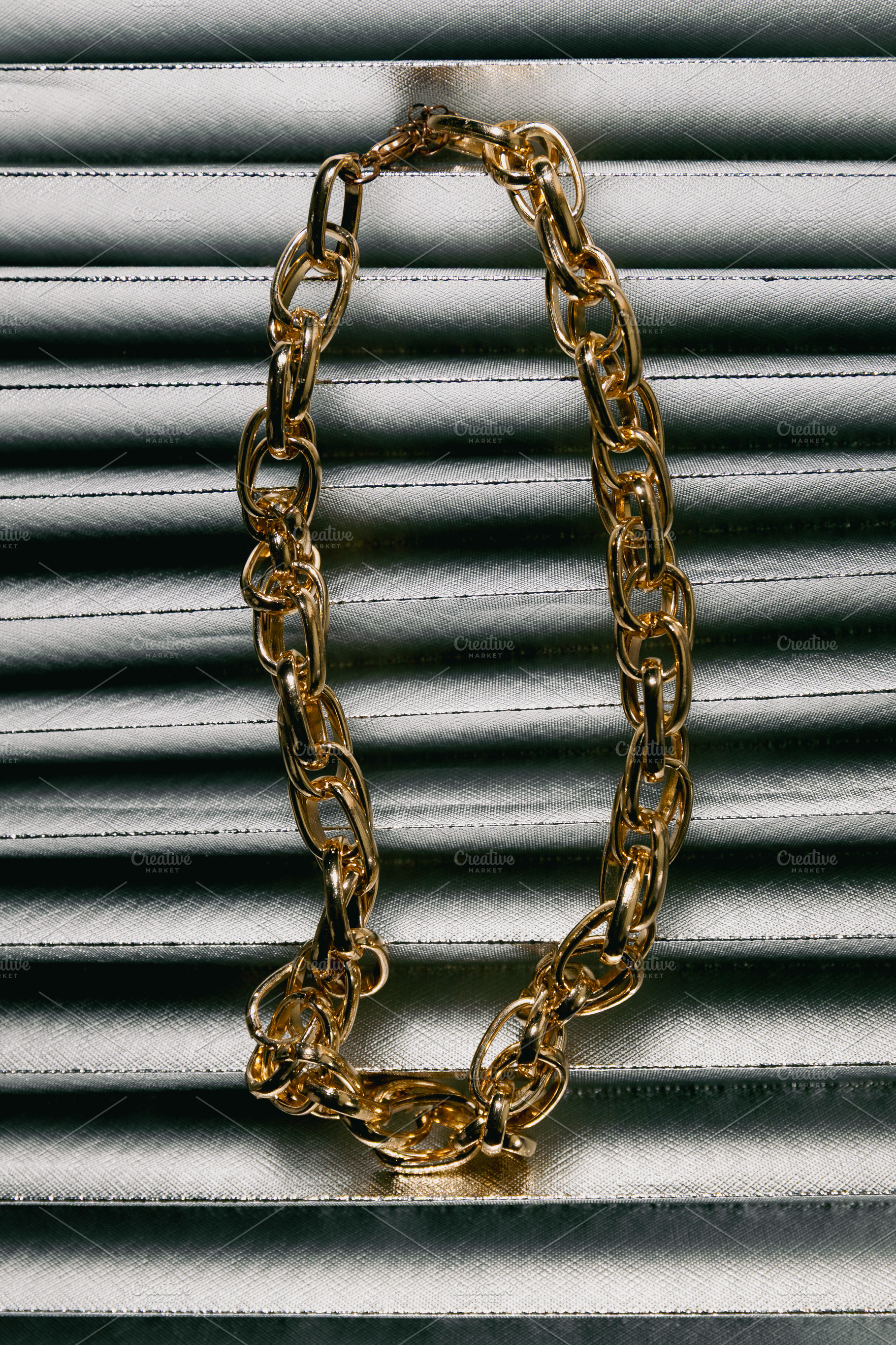 Golden chain necklace on metallic fa, a Beauty & Fashion Photo by Edalin's Store