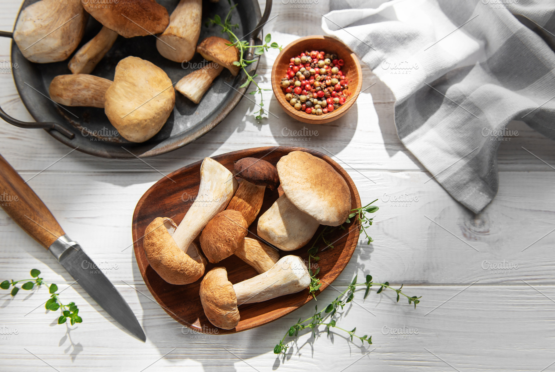 Porcini mushrooms with fresh herbs and spices on wooden table, a Food & Drink Photo by Olena Rudo