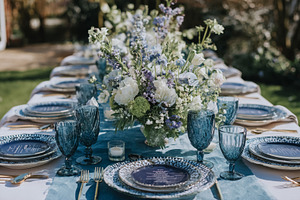 Outdoor wedding reception table setting featuring blue theme dec, a Photo by Studio ANNA
