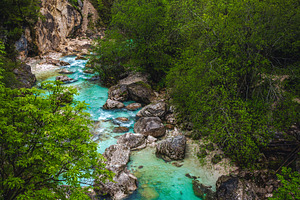 Soca river with rocky shoreline, a Nature Photo by Alpine Dreams