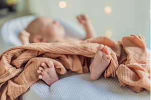 Newborn baby comfortably resting in, a Health & Medical Photo by Elizaveta Galitskaya