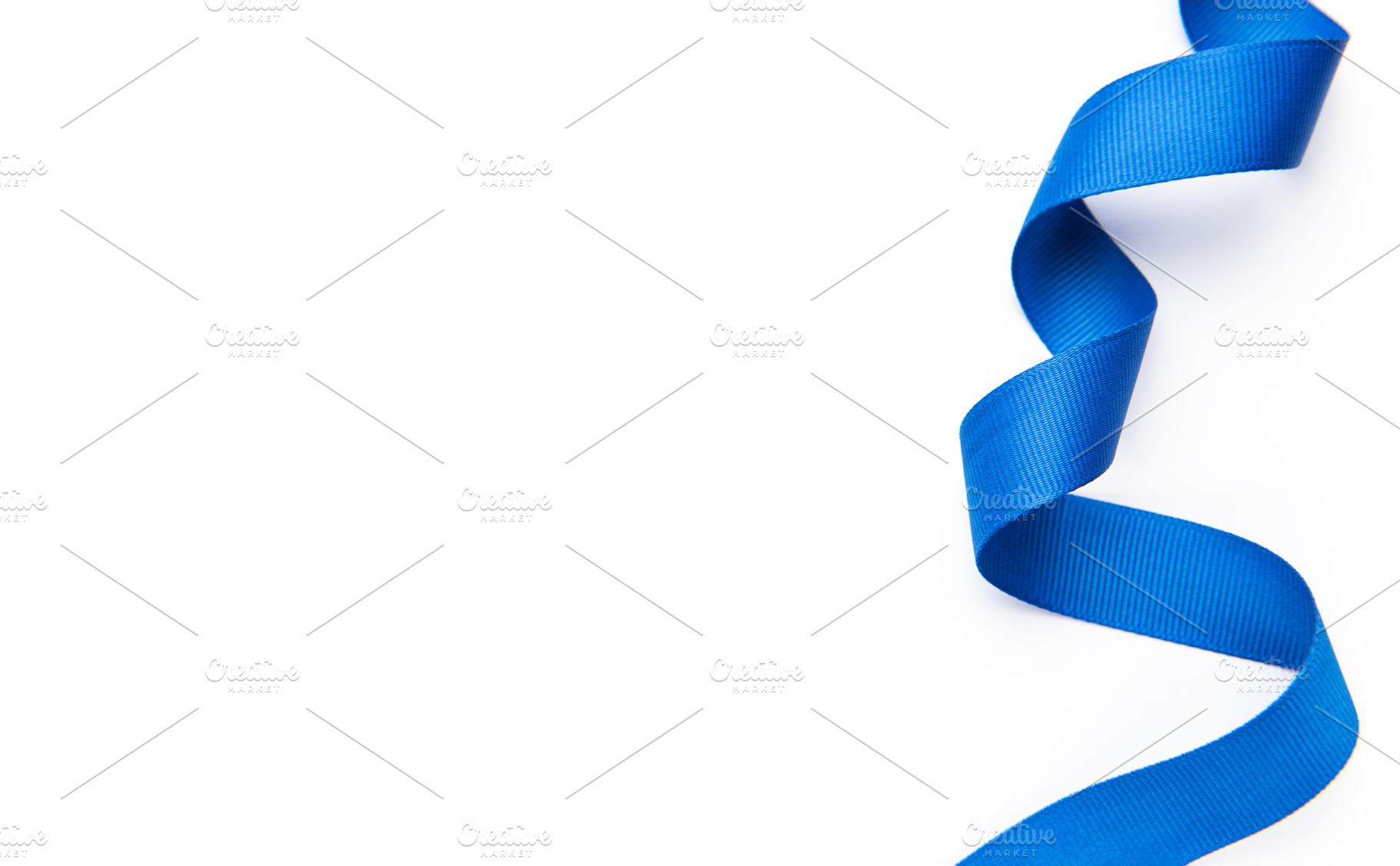 Blue ribbon curling on white background for celebtation, a Photo by Olena Rudo