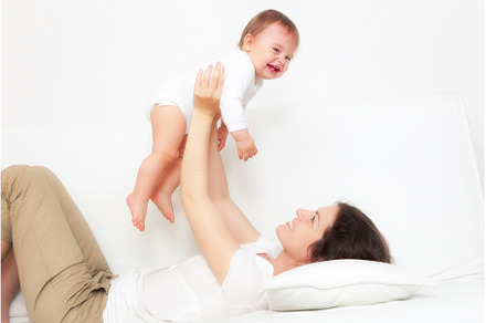 Mother playing with baby on white, a Person Photo by sborisov