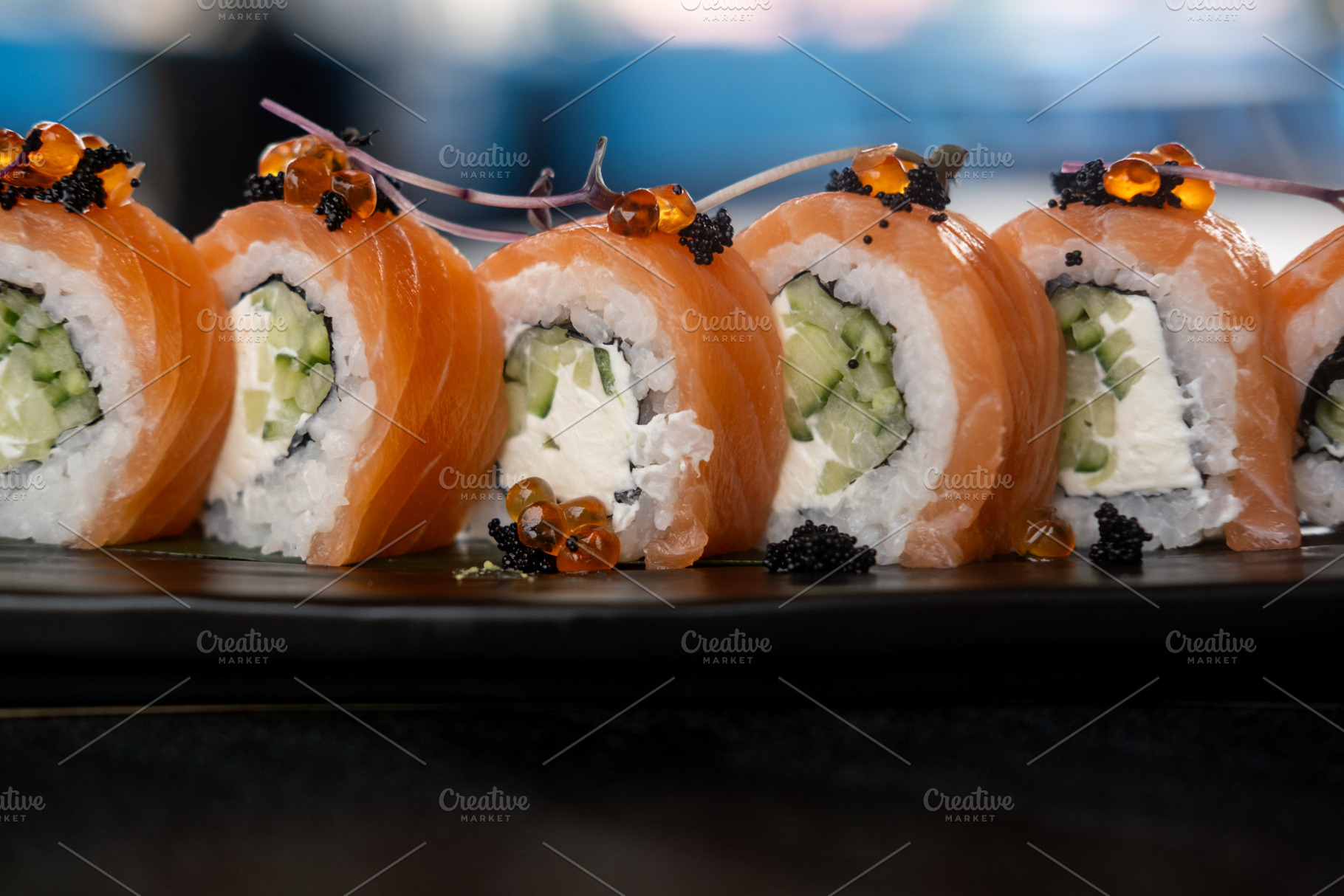 Salmon roll seafood dish row rice ikura platter, a Food & Drink Photo by Photo Drive Studio