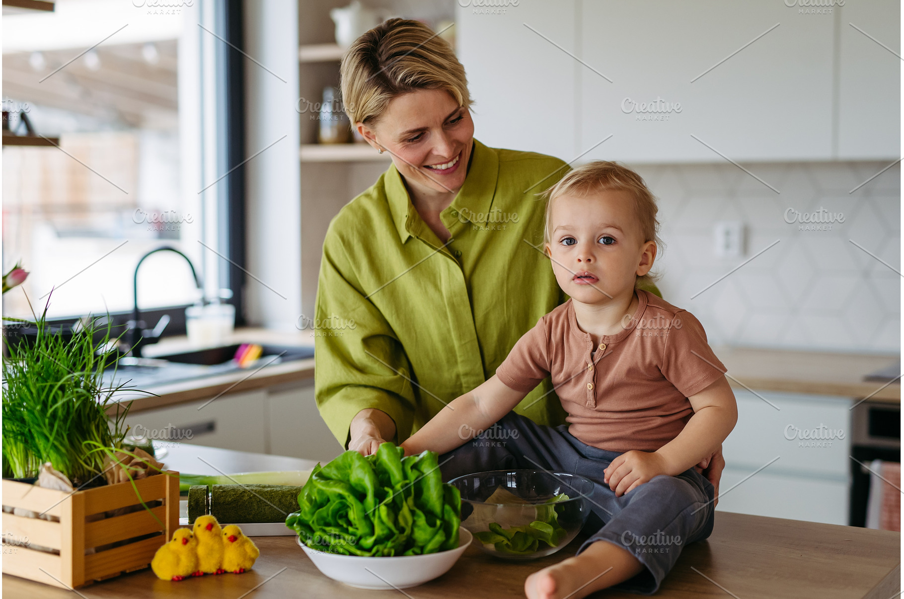 Mom and little boy preparing lettuce, a Food & Drink Photo by HalfPoint