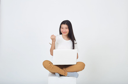 woman sitting using laptop sitting on gray background, a Person Photo by 1981 Rustic studio kan