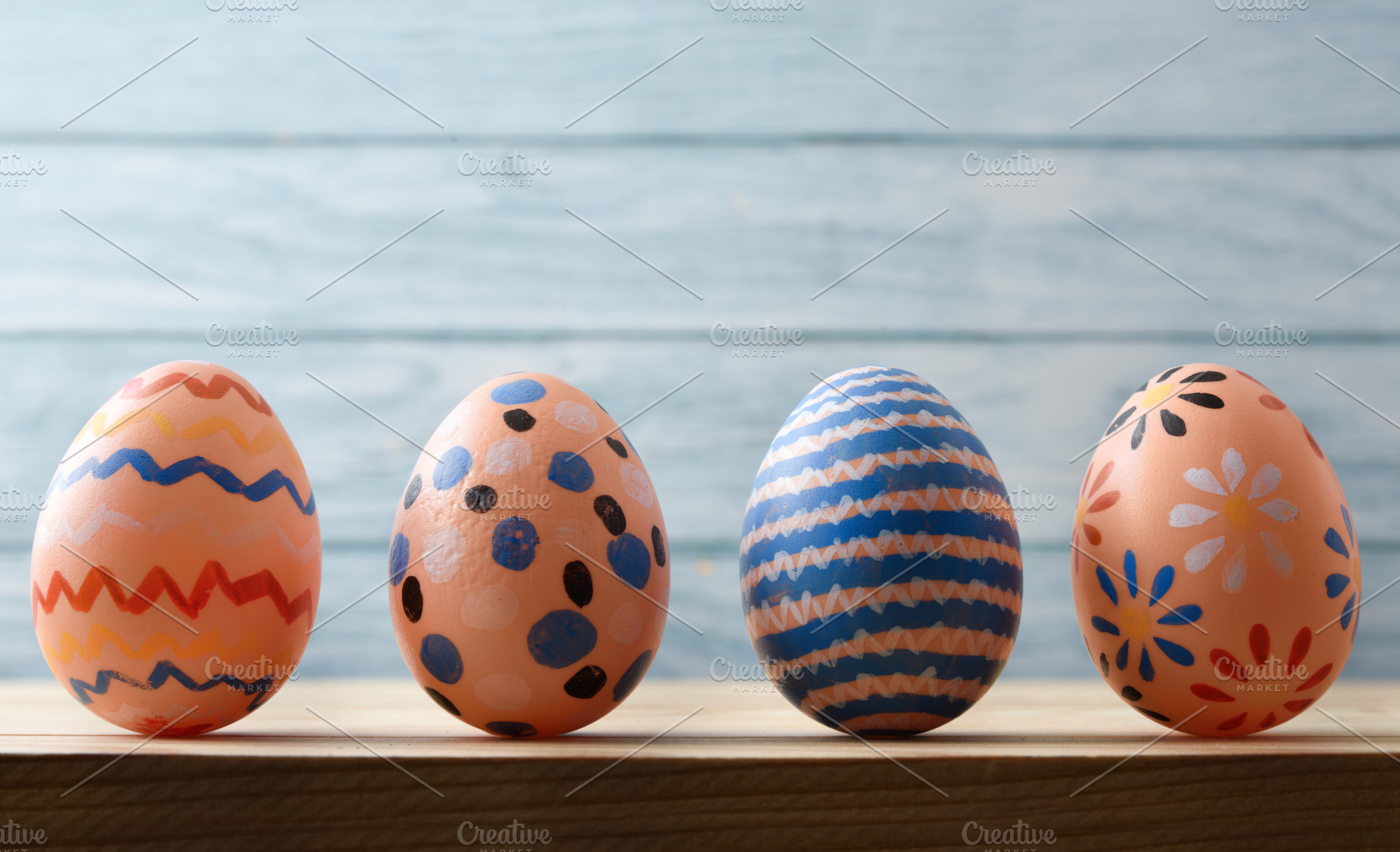 Hand-Painted Easter Eggs on Wooden Background, a Holiday Photo by Davizro's Market