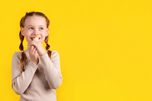 Happy young girl with pigtails eating a banana against a vibrant, a Person Photo by Ales Munt