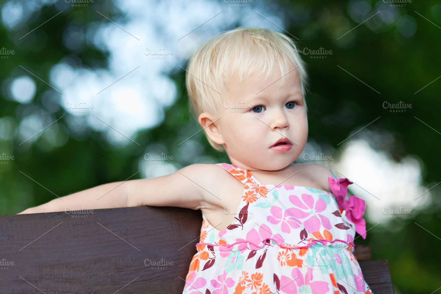 Baby sitting on the bench, a Photo by saiko3p