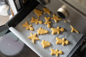 Raw Christmas cookies arranged on baking tray, a Food & Drink Photo by etorres69