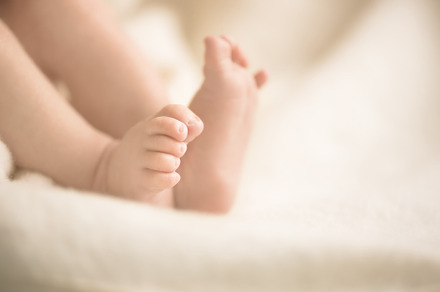 Newborn baby feet on creamy blanket mom and her child maternity family birth, a Person Photo by Enjoy Photo