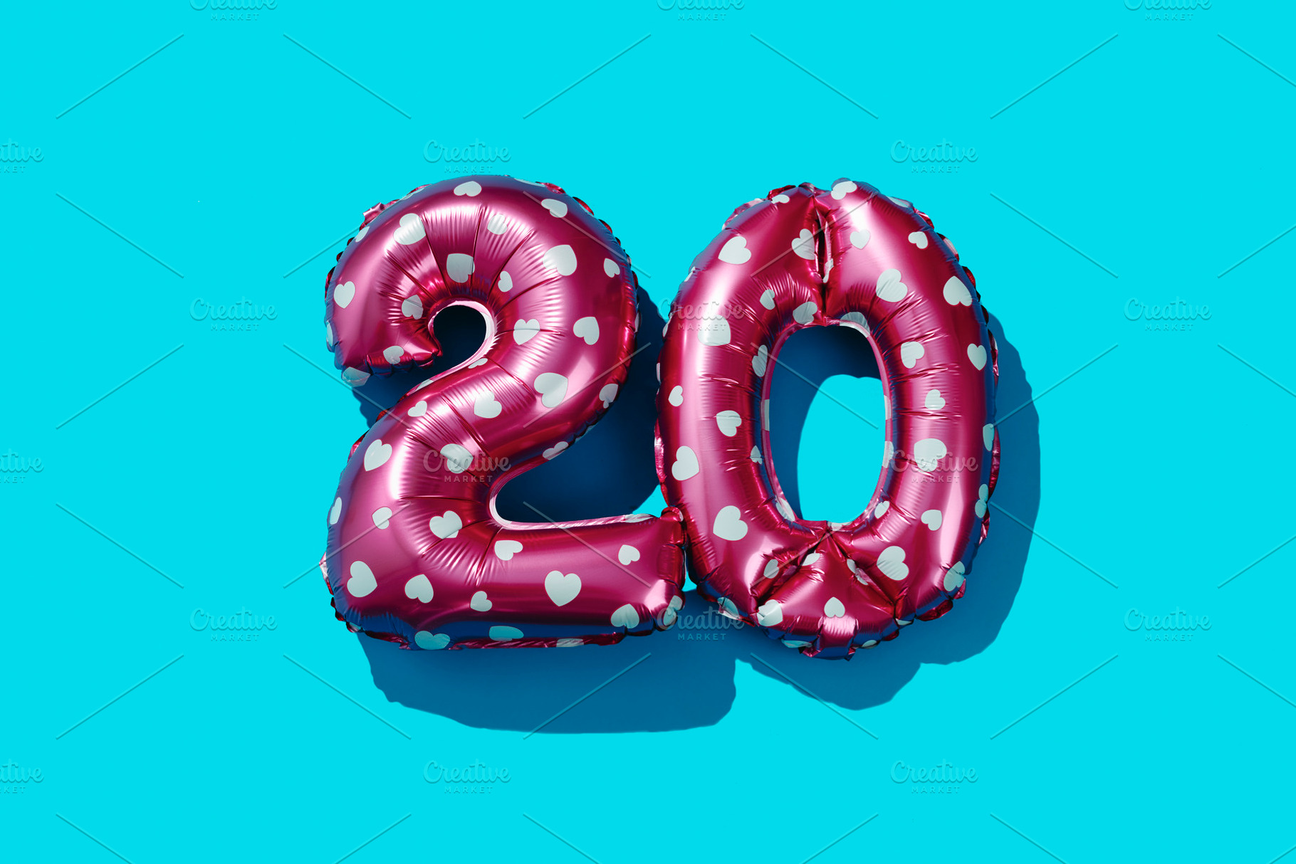 pink balloons forming the number 20 on blue, a Photo by Nito