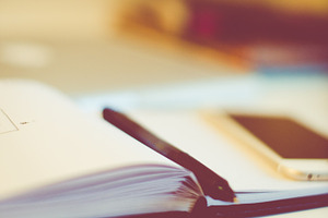 Sketchbook with iphone stock photo containing freelancer and desk