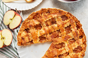 Homemade apple pie with a slice and fresh apples, a Food & Drink Photo by Olena Rudo
