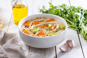 Homemade chicken soup in white bowl with carrots and celery, a Food & Drink Photo by etorres69