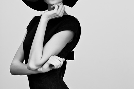 Woman retro fashion portrait featuring black, white, and hat
