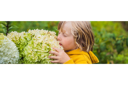 Boy enjoying pink flowers in the, a Nature Photo by Elizaveta Galitskaya