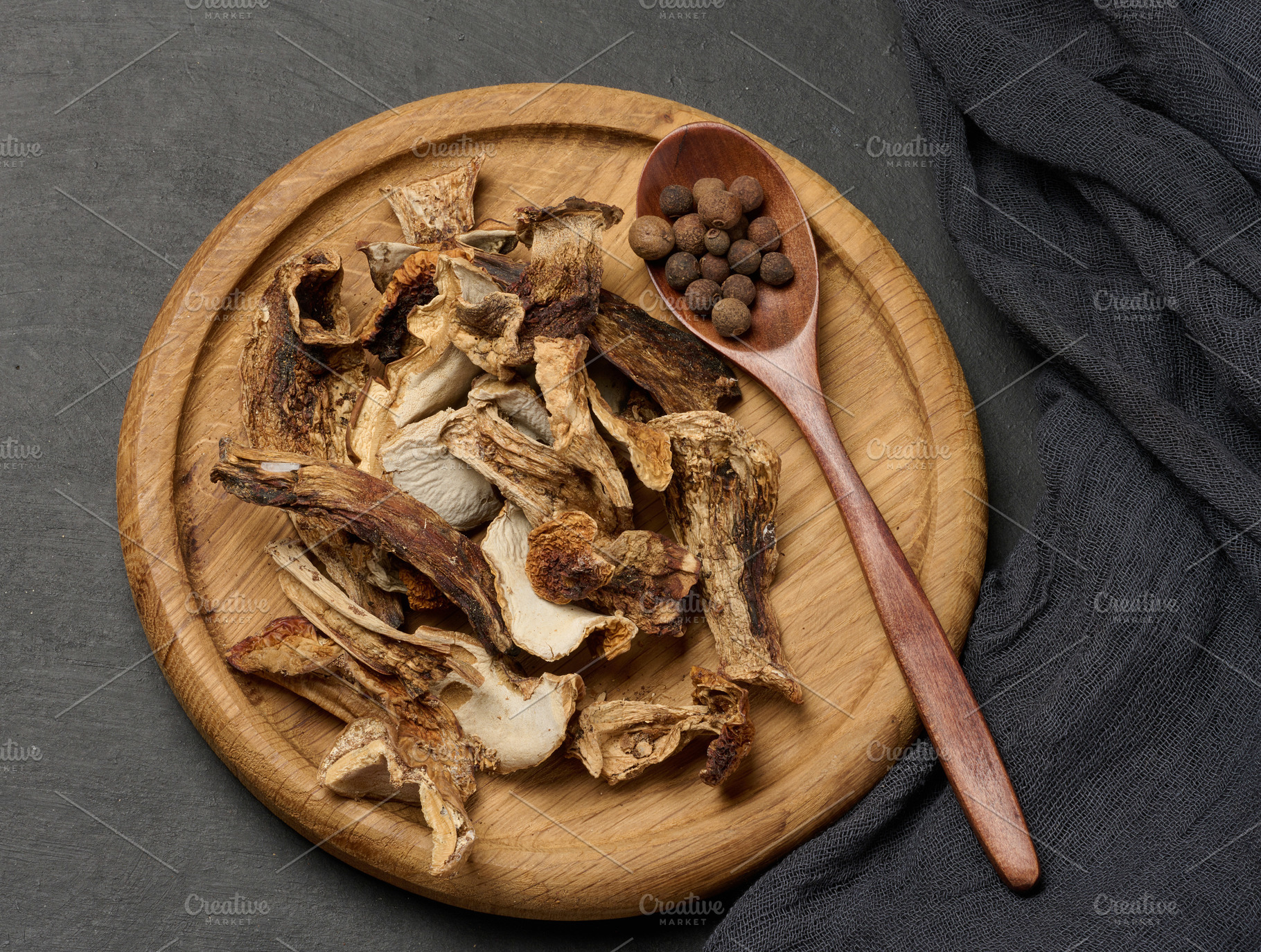 Dried forest mushrooms in a wooden plate, a Food & Drink Photo by ndanko