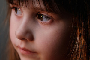 Softly lit portrait focusing on the child's delicate features and side view., a Person Photo by Rohan Photography