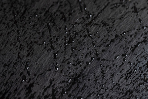 covered with water droplets natural stone black slate is used for decorative pu, a Photo by rsoollAI