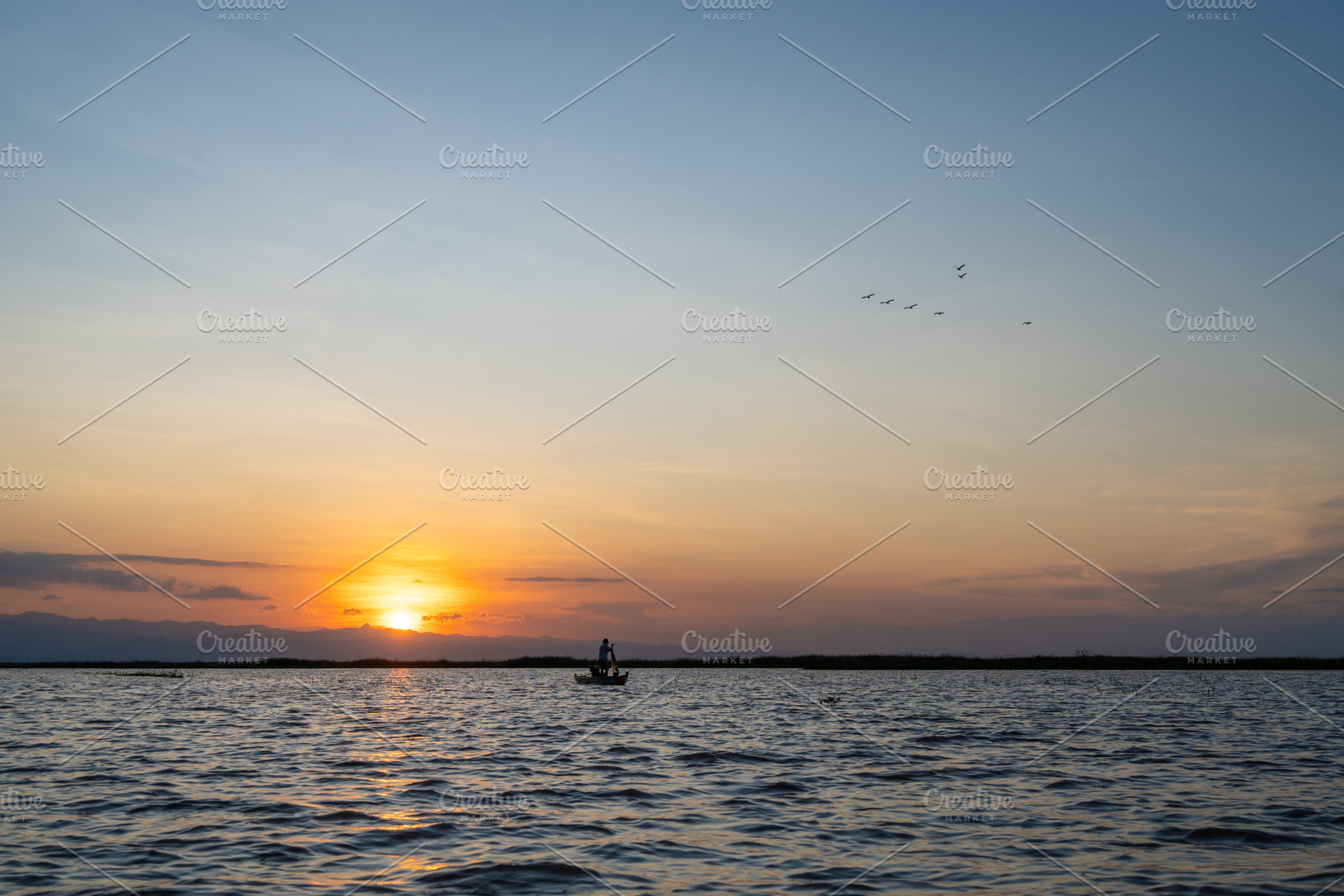 Boat at sunset on Lake Tempe, Sulawesi, Indonesia, a Nature Photo by GoodGoods