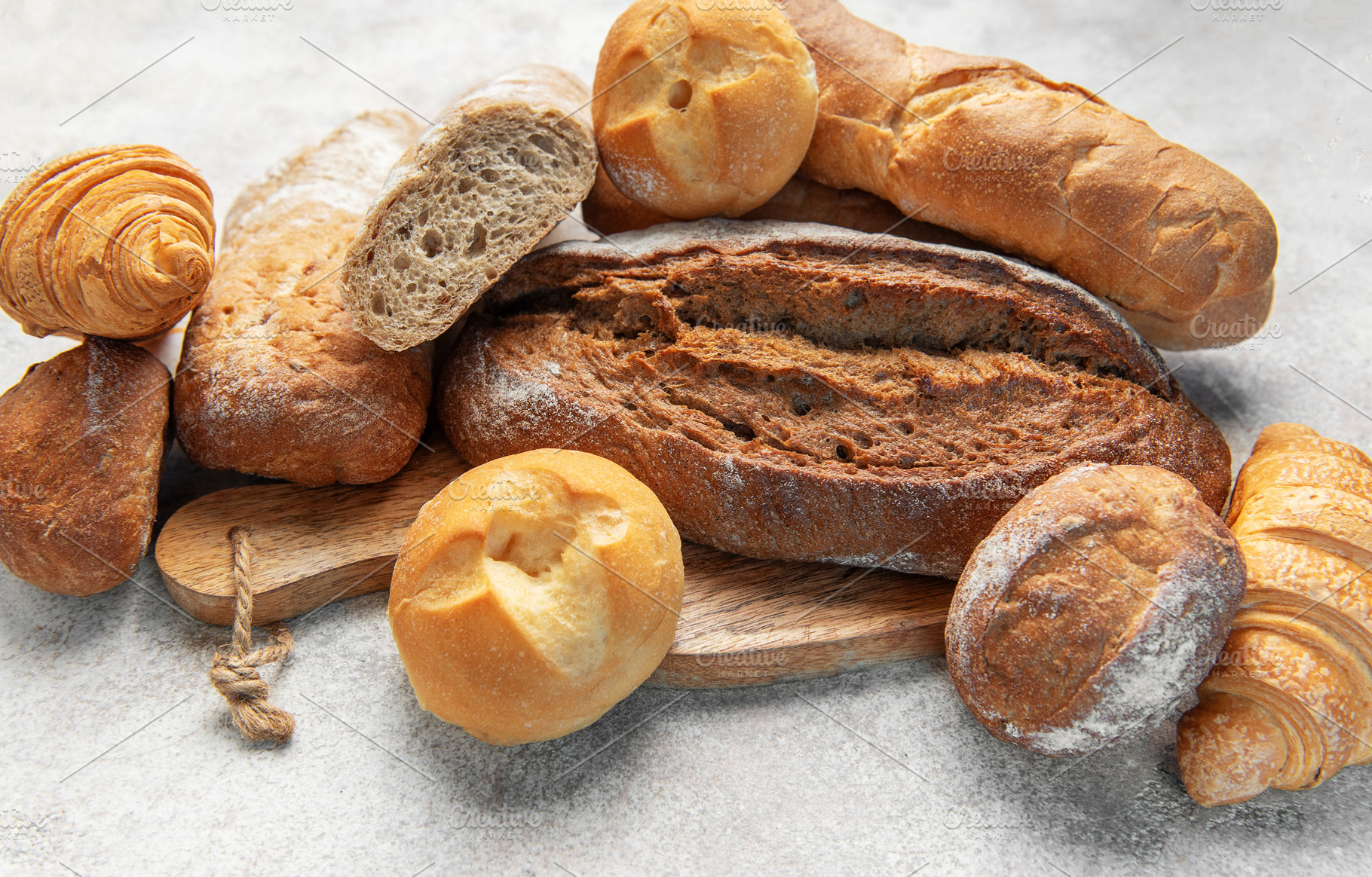 Assortment of fresh baked crusty artisan bread and croissants, a Food & Drink Photo by Olena Rudo