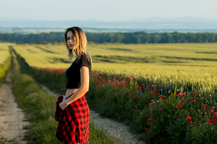 Young woman stay near suitcase on countryside road in summer tim, a Person Photo by Masson Simon