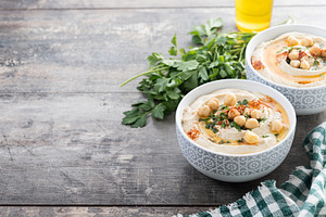 Chickpea hummus with olive oil, parsley and paprika in bowl on w, a Food & Drink Photo by etorres69