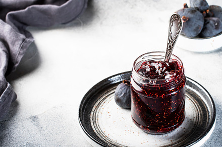 Fig confiture in glass jar. Fresh fruits on gray kitchen table,, a Food & Drink Photo by 5PH