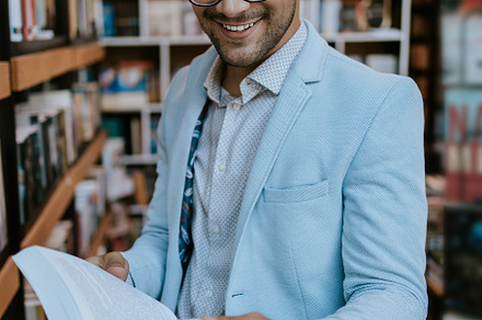 Young man in library, a School & Education Photo by REDDOT Studio