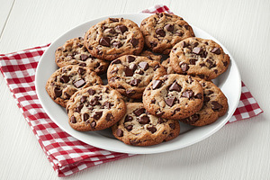 Delicious chocolate chip cookies arranged on a serving plate for dessert enjoym, a Food & Drink Photo by AlyaAnd