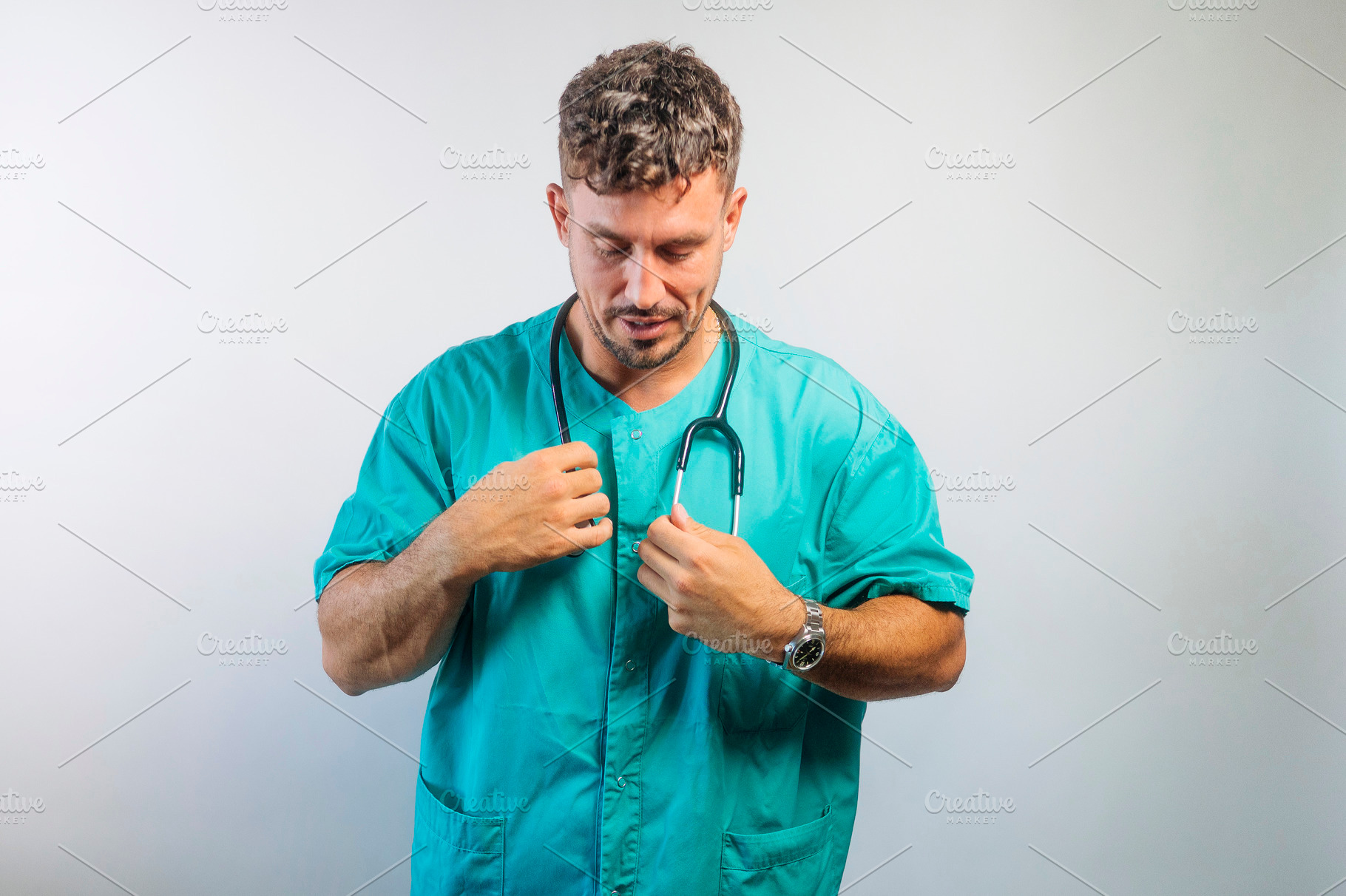 Doctor Adjusting His Stethoscope, a Person Photo by karrastock
