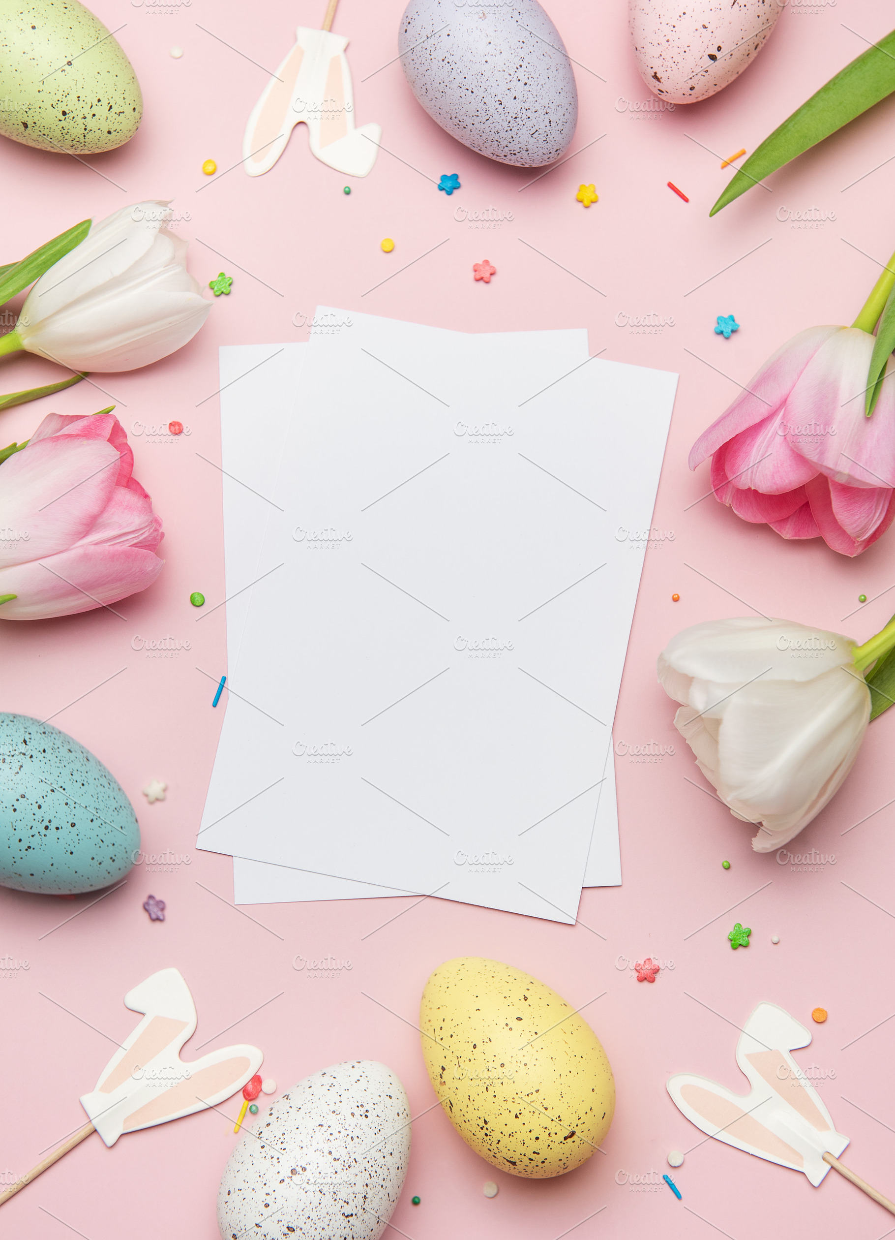 Easter greeting card mockup with colorful eggs and tulips on pin, a Photo by Olena Rudo