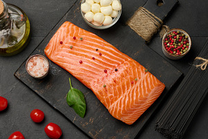 Composition of fresh ingredients salmon piece, cherry tomatoes,, a Food & Drink Photo by ndanko