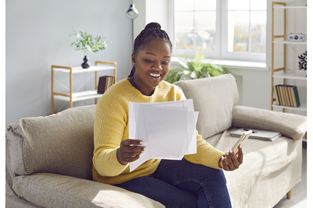 Happy woman sitting on the sofa at, a Person Photo by StudioRomantic