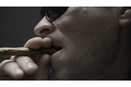 A young man with a cigar at a card, a Person Photo by Media Whale Stock
