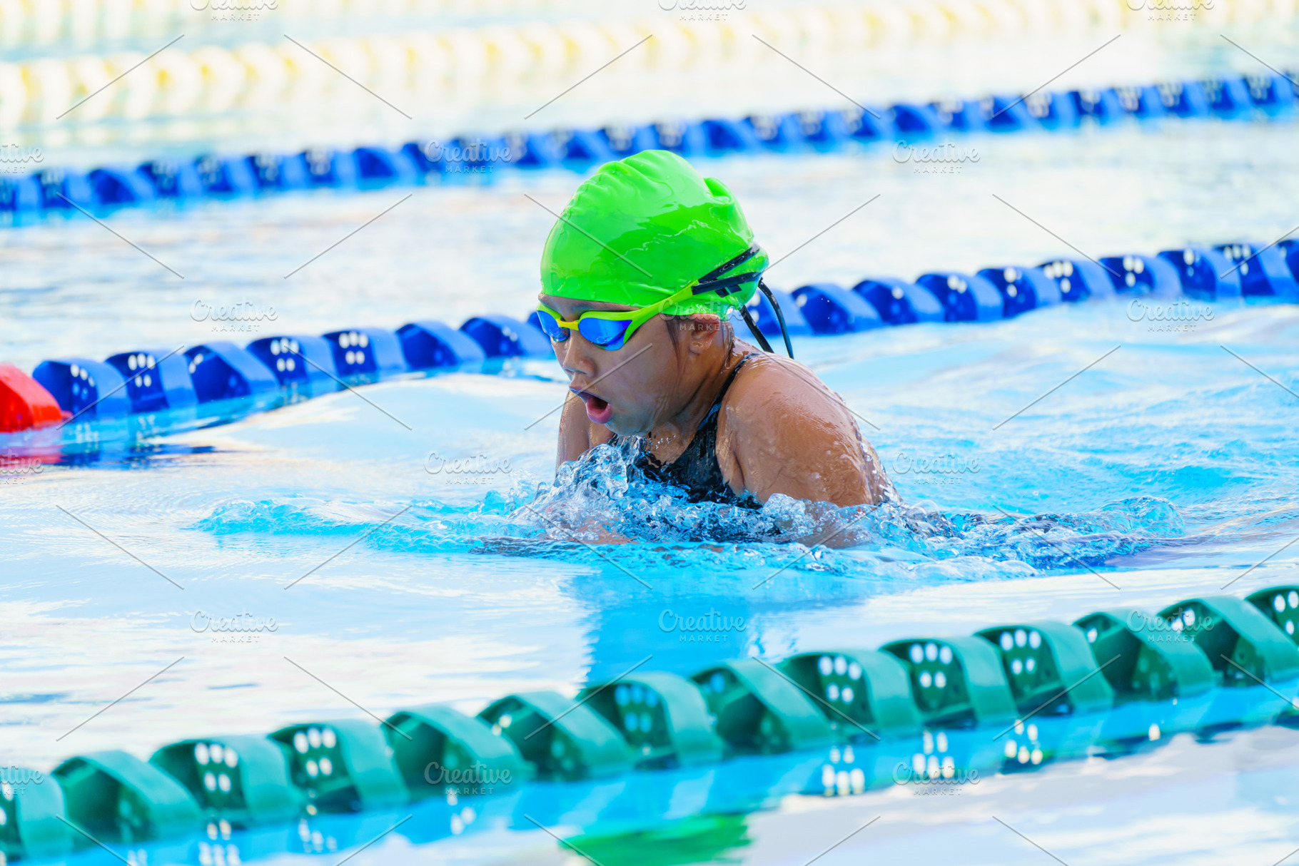 Swimmer child swims breaststroke swimming style in a race swimmi, a Sports & Recreation Photo by Casanowe-studio
